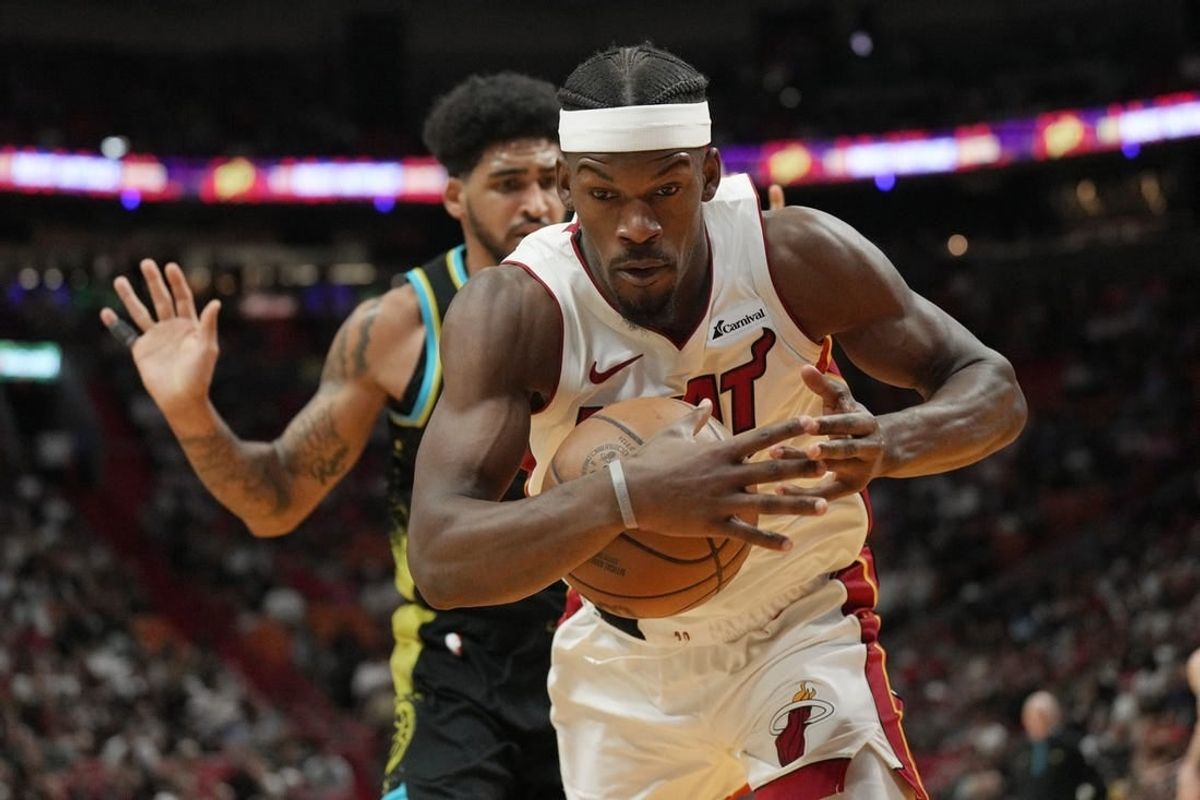 Dec 2, 2023; Miami, Florida, USA;  Miami Heat forward Jimmy Butler (22) gets fouled by Indiana Pacers forward Obi Toppin (1) during the second half at Kaseya Center.