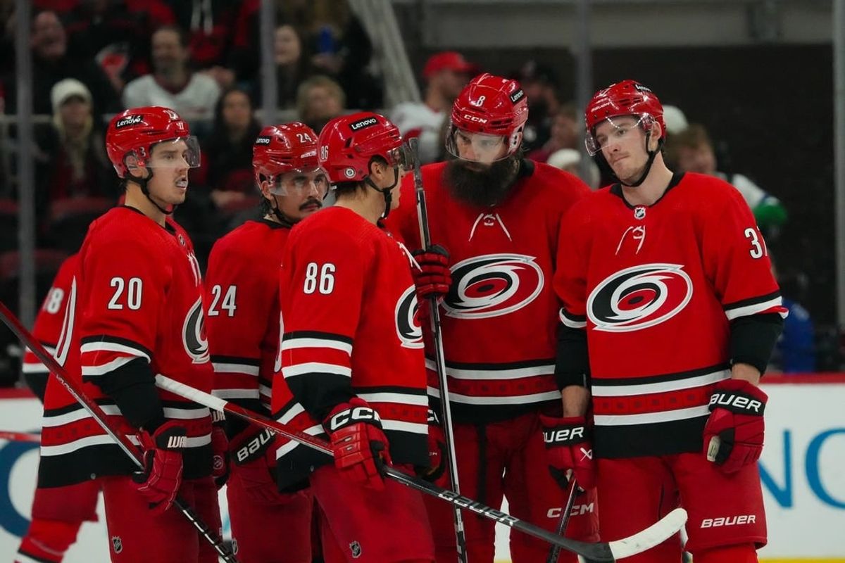 Nov 26, 2023; Raleigh, North Carolina, USA;  Carolina Hurricanes center Sebastian Aho (20) center Seth Jarvis (24) left wing Teuvo Teravainen (86) defenseman Brent Burns (8) and right wing Andrei Svechnikov (37) talk against the Columbus Blue Jackets during the third period at PNC Arena.