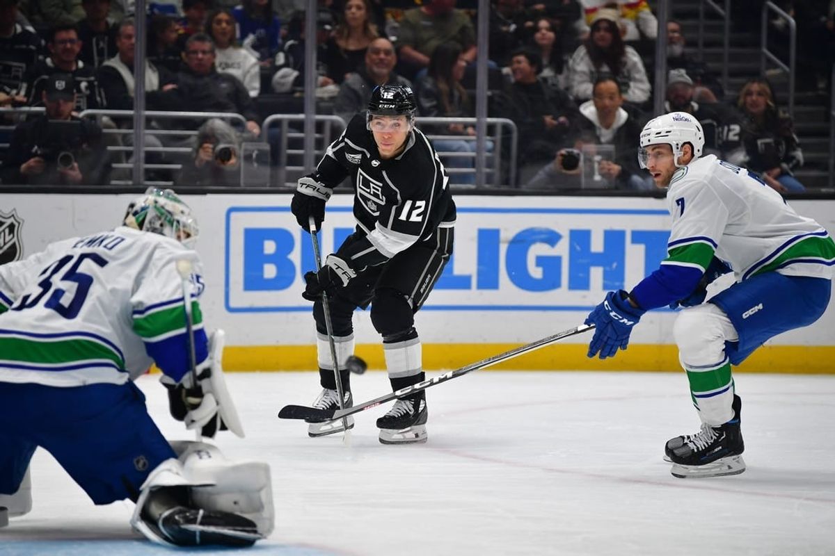 Mar 5, 2024; Los Angeles, California, USA; Los Angeles Kings left wing Trevor Moore (12) shoots on goal against Vancouver Canucks defenseman Carson Soucy (7) and goaltender Thatcher Demko (35) during the second period at Crypto.com Arena.