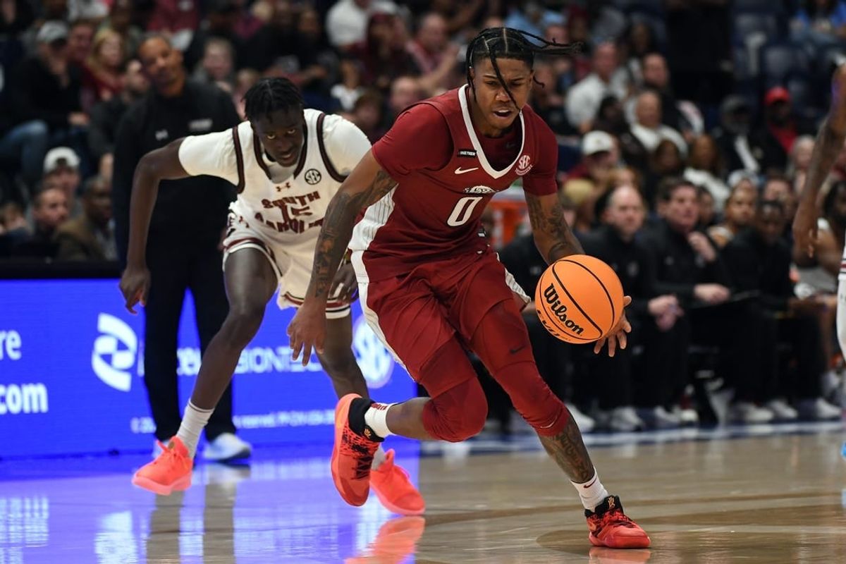 Mar 14, 2024; Nashville, TN, USA; Arkansas Razorbacks guard Khalif Battle (0) goes for a loose ball after a steal from South Carolina Gamecocks guard Morris Ugusuk (15) during the second half at Bridgestone Arena.