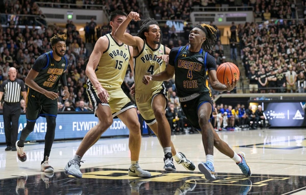 Nov 10, 2023; West Lafayette, Indiana, USA; Morehead State Eagles guard Eddie Ricks III (4) drives toward the basket in front of Purdue Boilermakers forward Trey Kaufman-Renn (4) and center Zach Edey (15) during the first half at Mackey Arena.