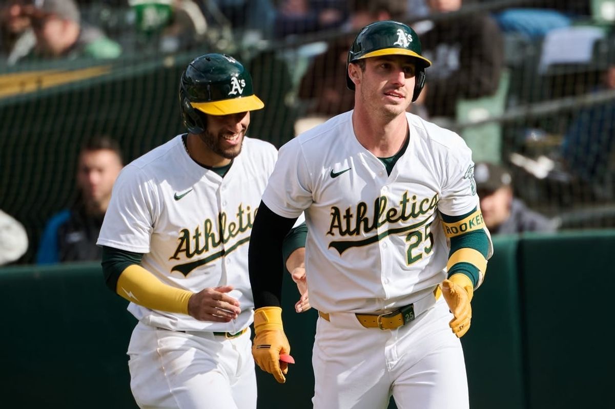 May 4, 2024; Oakland, California, USA; Oakland Athletics designated hitter Brent Rooker (25) returns to the dugout with infielder Abraham Toro (31) after hitting his second home run of the third inning against the Miami Marlins at Oakland-Alameda County Coliseum.