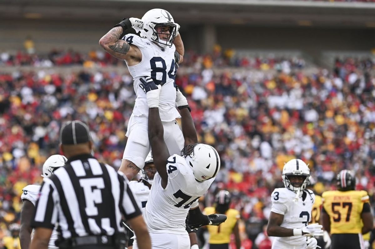 Nov 4, 2023; College Park, Maryland, USA;  Penn State Nittany Lions offensive lineman Olumuyiwa Fashanu (74) celebrates with  tight end Theo Johnson (84) after scoring a first half touchdown against the Maryland Terrapins at SECU Stadium.