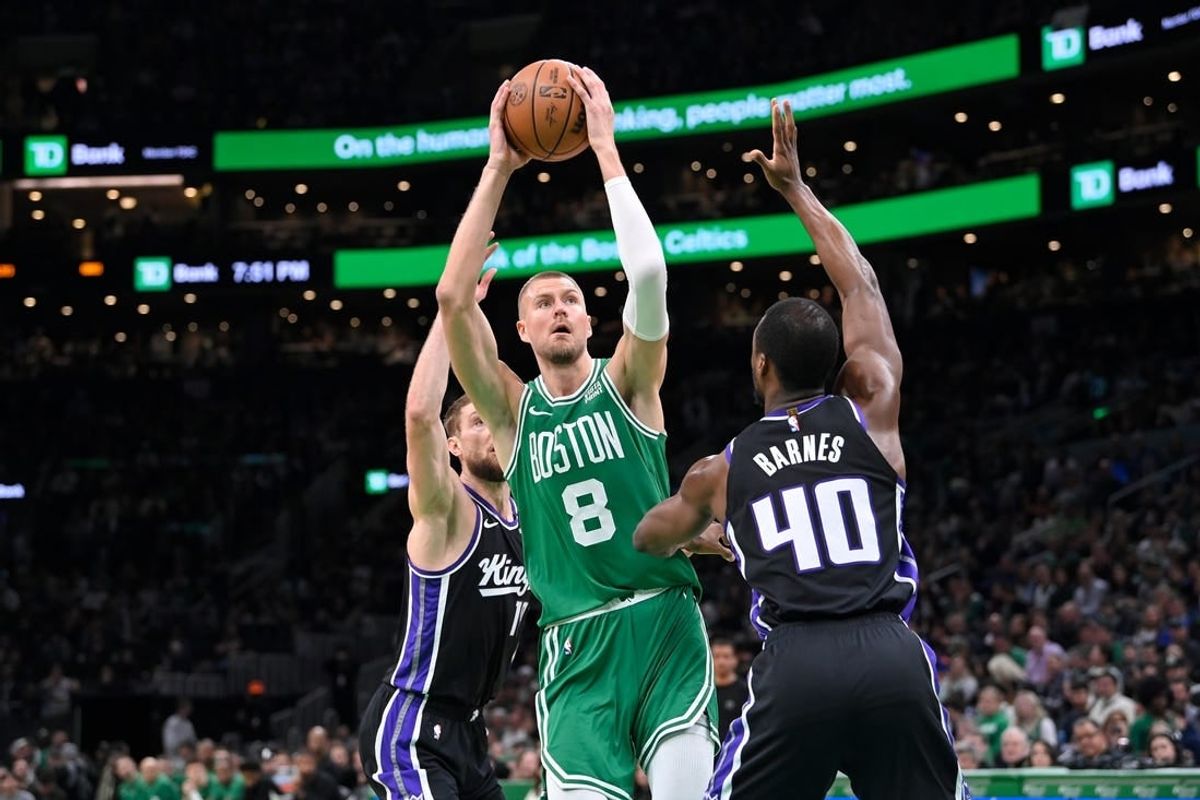 Apr 5, 2024; Boston, Massachusetts, USA; Boston Celtics center Kristaps Porzingis (8) shoots the ball against the Sacramento Kings during the first half at TD Garden.