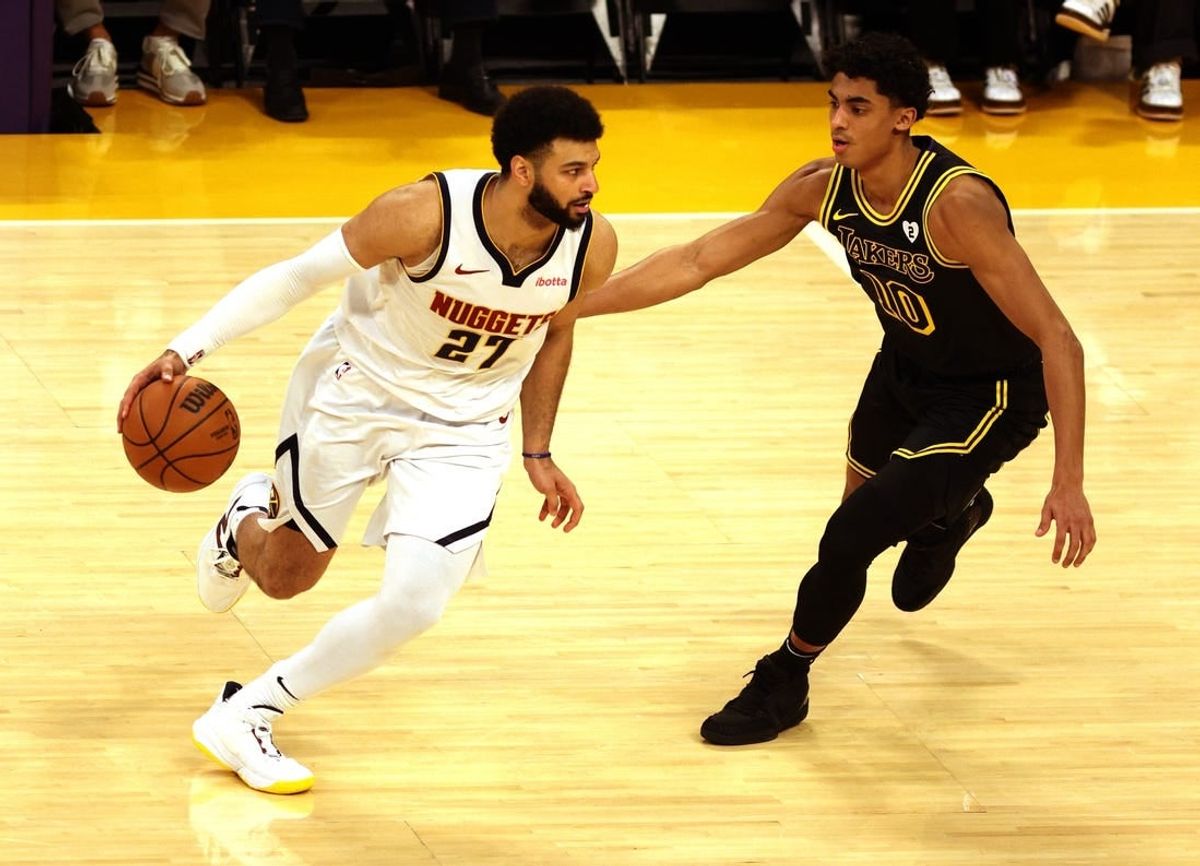 Feb 8, 2024; Los Angeles, California, USA; Denver Nuggets guard Jamal Murray (27) dribbles against Los Angeles Lakers guard Max Christie (10) during the first quarter at Crypto.com Arena.