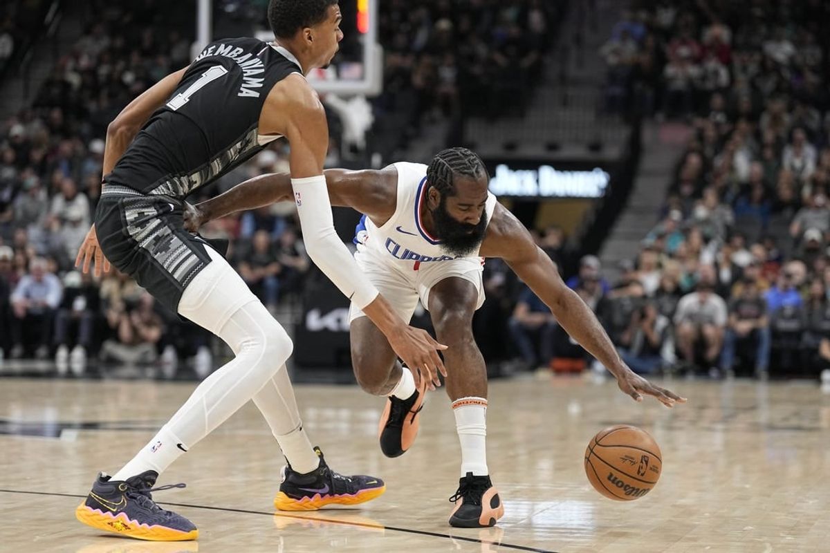 Nov 22, 2023; San Antonio, Texas, USA; Los Angeles Clippers guard James Harden (1) loses control of the ball while defended by San Antonio Spurs forward Victor Wembanyama (1) during the first half at Frost Bank Center.