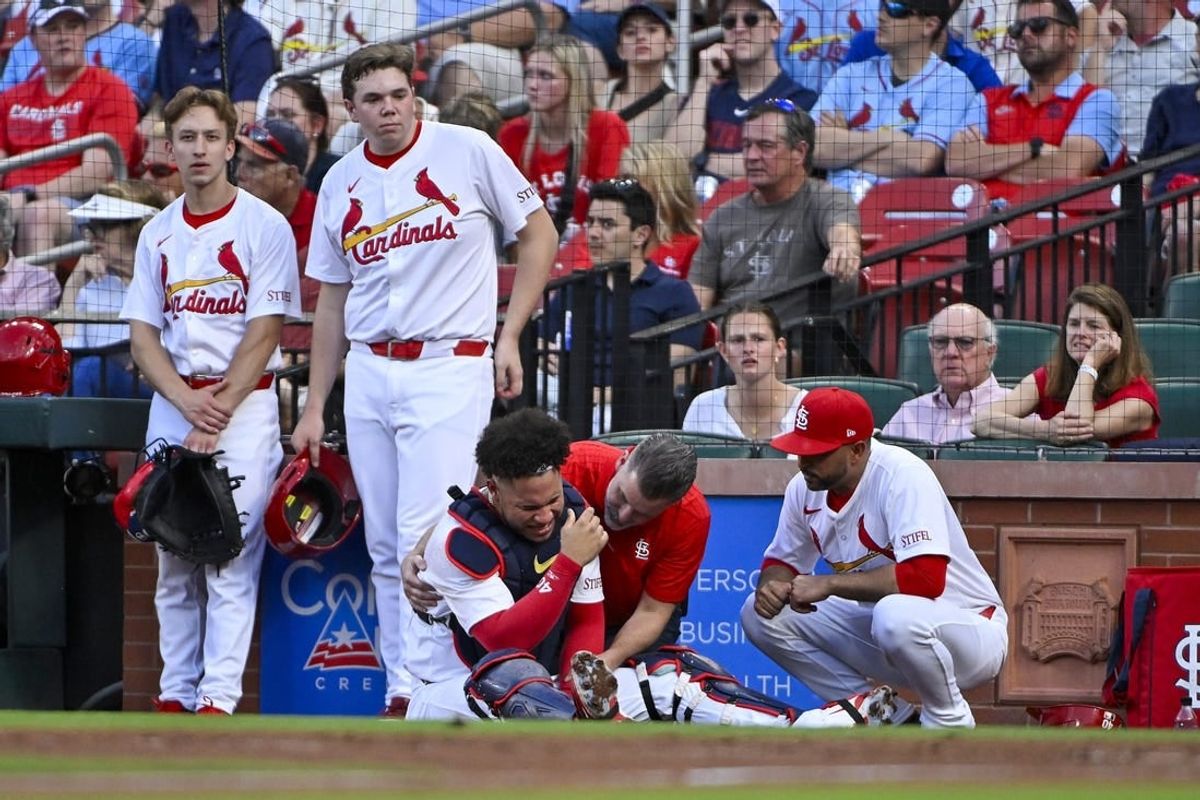 May 7, 2024; St. Louis, Missouri, USA;  St. Louis Cardinals catcher Willson Contreras (40) is checked on by a trainer and manager Oliver Marmol (37) after fracturing his left arm during the second inning against the New York Mets at Busch Stadium.