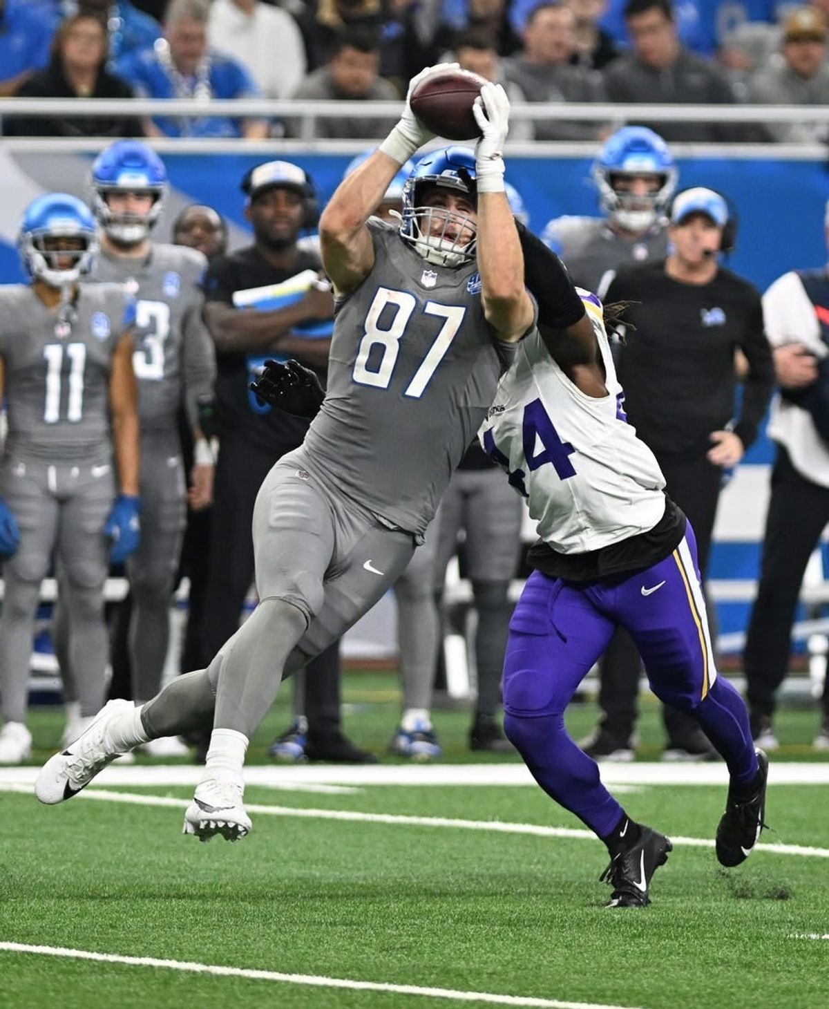 Jan 7, 2024; Detroit, Michigan, USA; Detroit Lions tight end Sam LaPorta (87) catches a pass in front of Minnesota Vikings safety Josh Metellus (44) in the second quarter at Ford Field.