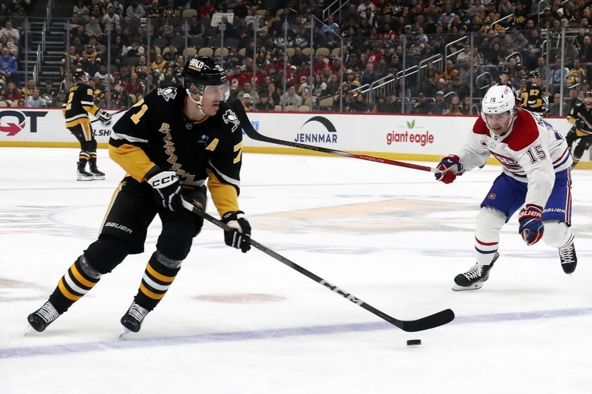 Feb 22, 2024; Pittsburgh, Pennsylvania, USA; Pittsburgh Penguins center Evgeni Malkin (71) skates with the puck as Montreal Canadiens center Alex Newhook (15) chases during the first period at PPG Paints Arena.