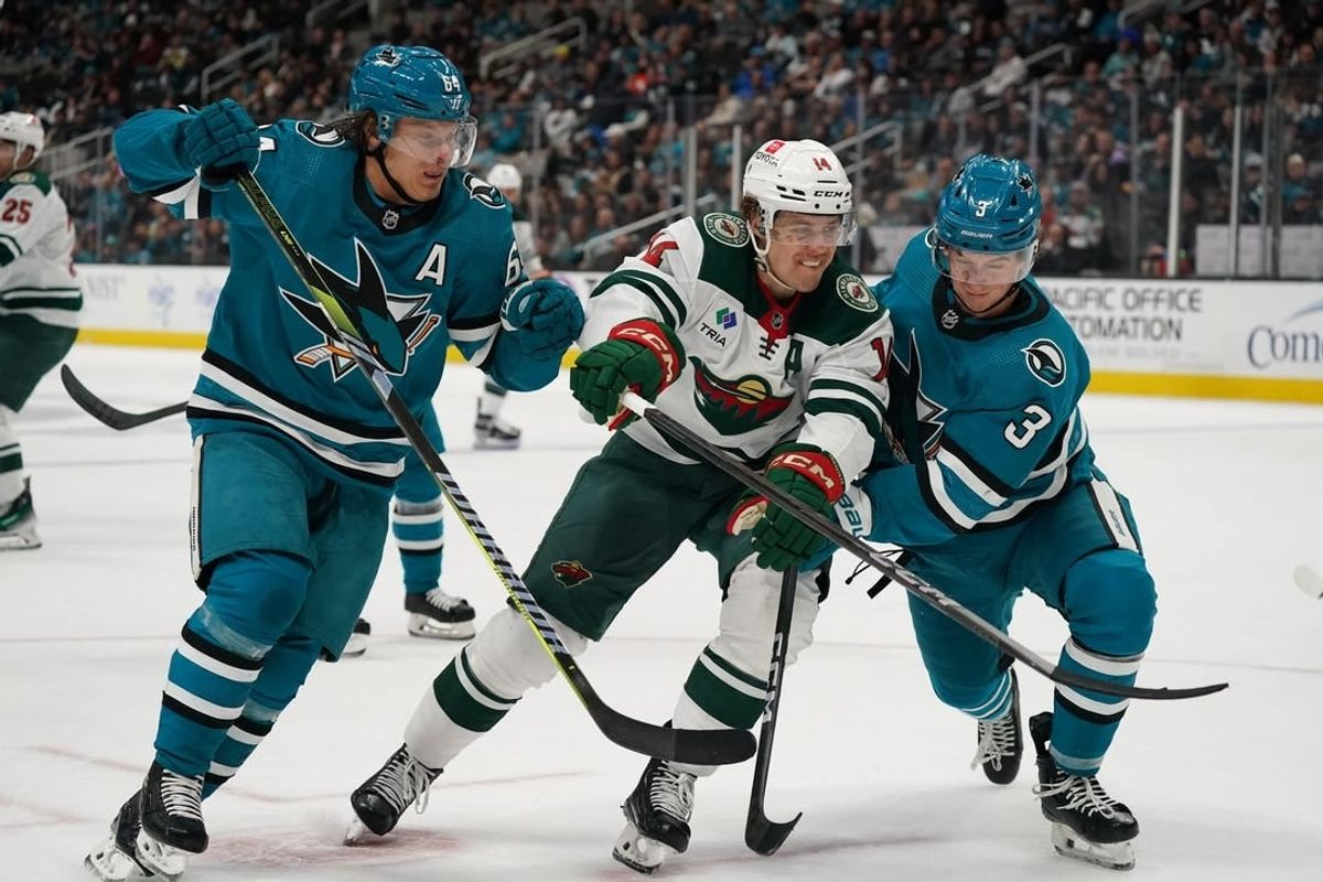 Apr 13, 2024; San Jose, California, USA; San Jose Sharks center Mikael Granlund (64), Minnesota Wild center Joel Eriksson Ek (14), and San Jose Sharks defenseman Henry Thrun (3) race to the puck during the first period at SAP Center at San Jose.