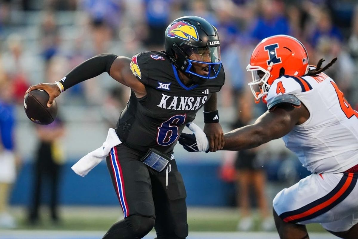 Sep 8, 2023; Lawrence, Kansas, USA; Kansas Jayhawks quarterback Jalon Daniels (6) against Illinois Fighting Illini defensive lineman Jer'Zhan Newton (4) during the first half at David Booth Kansas Memorial Stadium.