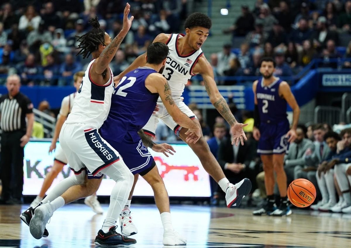 Nov 11, 2023; Hartford, Connecticut, USA; UConn Huskies forward Jaylin Stewart (3) and guard Stephon Castle (5) defend against Stonehill Skyhawks Pano Pavlidis (22) in the first half at XL Center.