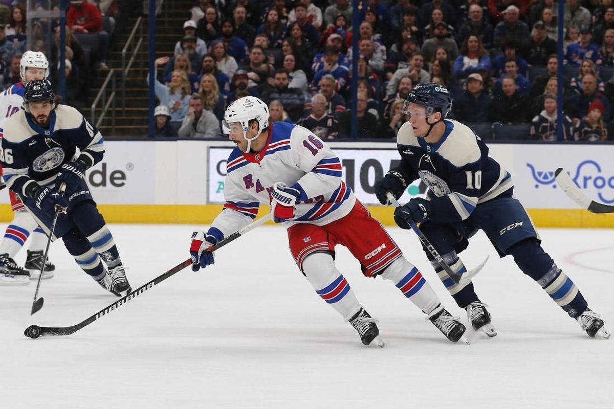 Feb 25, 2024; Columbus, Ohio, USA; New York Rangers center Vincent Trocheck (16) carries the puck as Columbus Blue Jackets left wing Dmitri Voronkov (10) trails the play during the first period at Nationwide Arena.