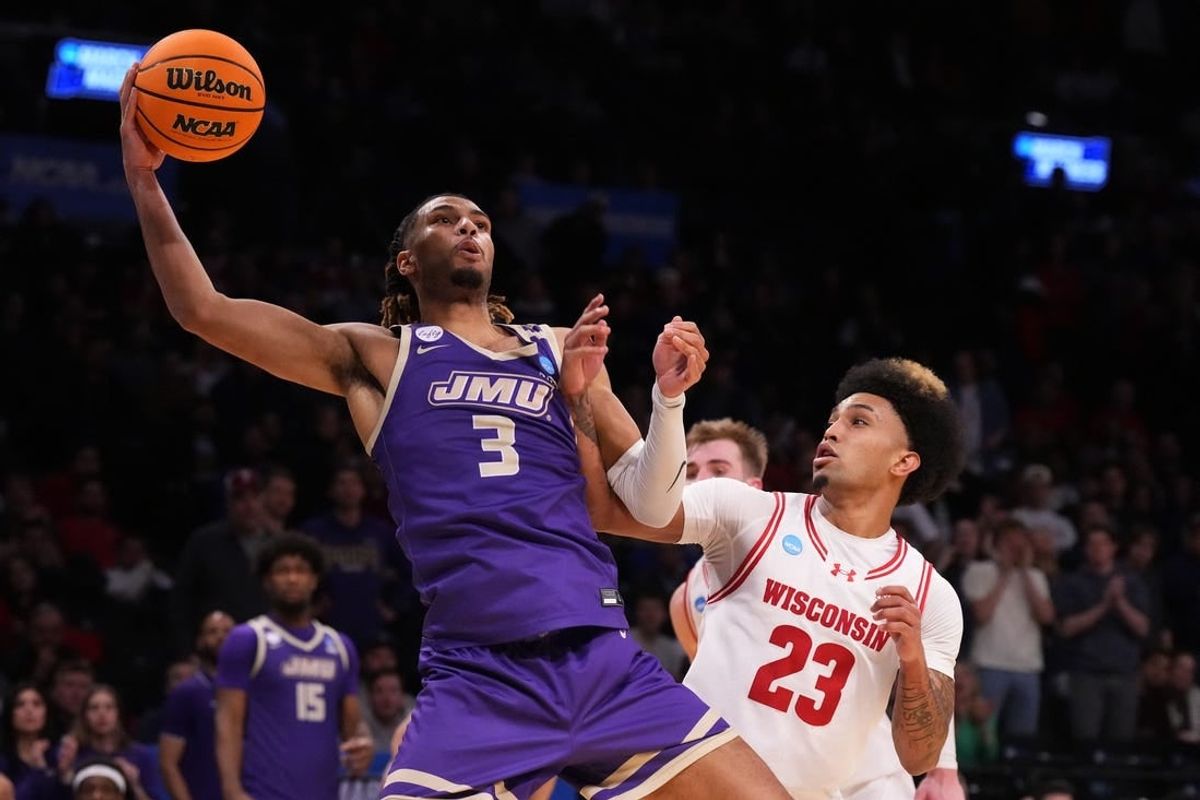 Mar 22, 2024; Brooklyn, NY, USA; James Madison Dukes forward T.J. Bickerstaff (3) shoots the ball over Wisconsin Badgers guard Chucky Hepburn (23) in the first round of the 2024 NCAA Tournament at the Barclays Center.