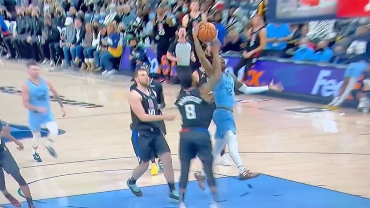 Marcus Morris Sr. tries to keep Ja Morant from the hoop by attempting to remove his head from his neck.