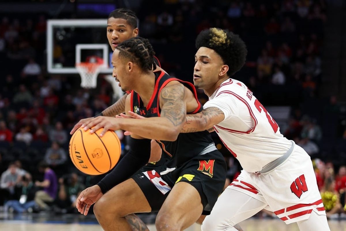 Mar 14, 2024; Minneapolis, MN, USA; Maryland Terrapins guard Jahmir Young (1) dribbles as Wisconsin Badgers guard Chucky Hepburn (23) defends during the first half at Target Center.