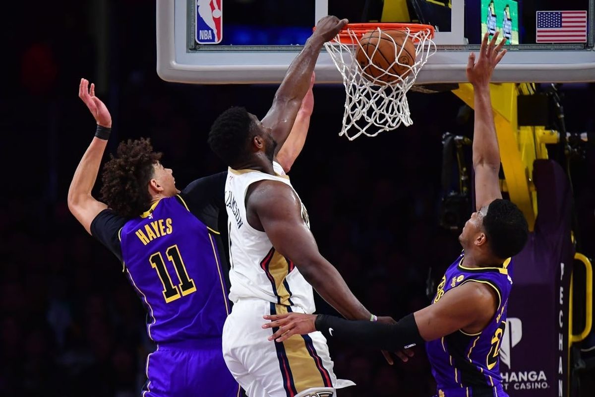 Feb 9, 2024; Los Angeles, California, USA; New Orleans Pelicans forward Zion Williamson (1) dunks for the basket against Los Angeles Lakers forward Rui Hachimura (28) and center Jaxson Hayes (11) during the first half at Crypto.com Arena.