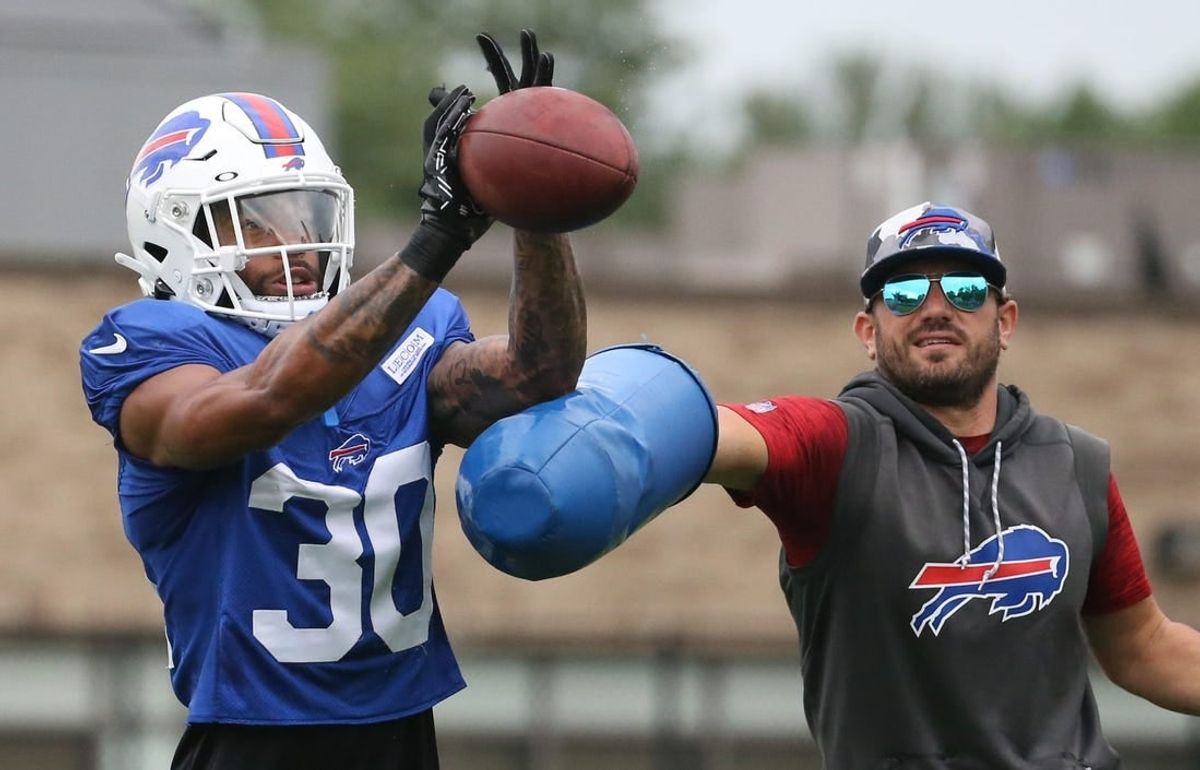 Bills cornerback Dane Jackson (30) eyes in the ball as he is hit by linebackers coach Bobby Babich during interception drills on day nine of Buffalo Bills training camp at St. John Fisher University in Rochester Thursday, Aug. 4, 2022.

Sd 080422 Bills Camp 1 Spts