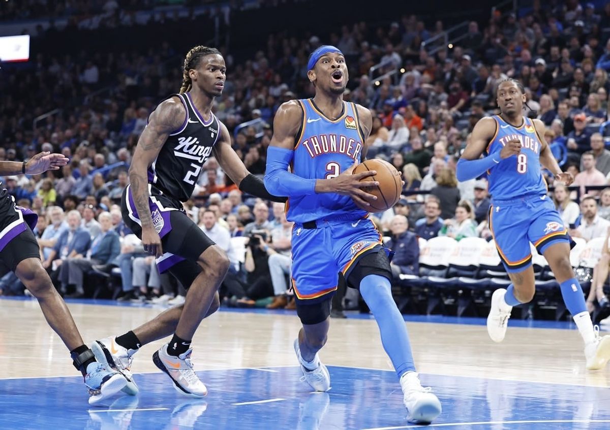 Apr 9, 2024; Oklahoma City, Oklahoma, USA; Oklahoma City Thunder guard Shai Gilgeous-Alexander (2) drives to the basket ahead of Sacramento Kings guard Keon Ellis (23) during the second half at Paycom Center.
