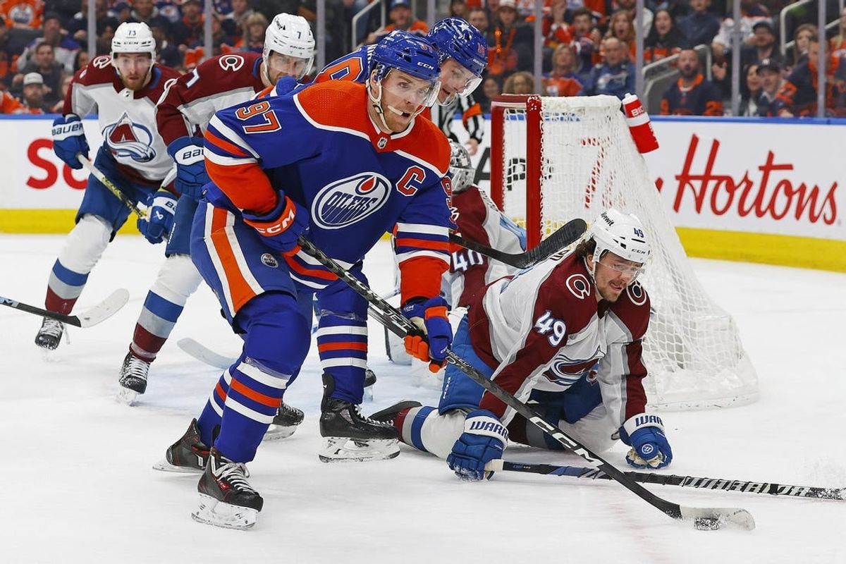 Mar 16, 2024; Edmonton, Alberta, CAN; Edmonton Oilers forward Connor McDavid (97) looks to make a pass in front of Colorado Avalanche defensemen Sam Girard (49) during the first period at Rogers Place.