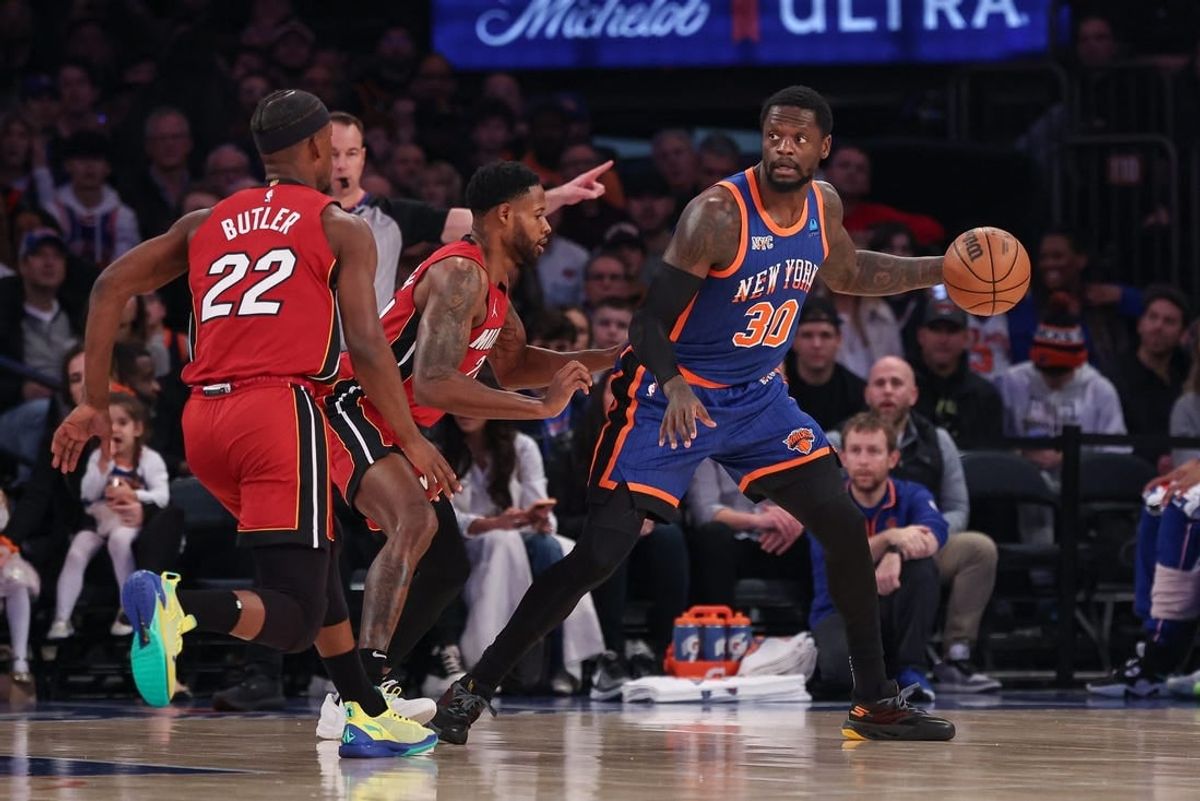 Jan 27, 2024; New York, New York, USA; New York Knicks forward Julius Randle (30) controls the ball as Miami Heat forward Haywood Highsmith (24) and forward Jimmy Butler (22) defend during the first half at Madison Square Garden.