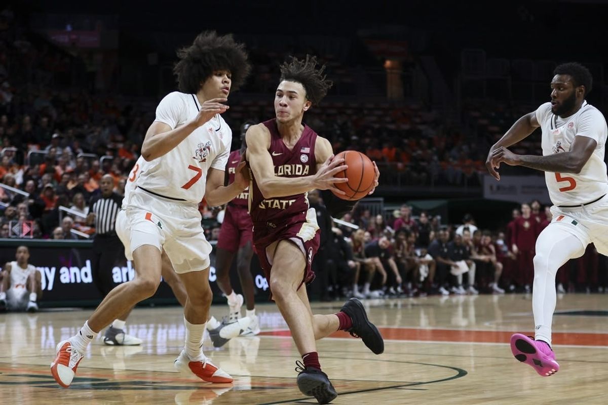 Jan 17, 2024; Coral Gables, Florida, USA; Florida State Seminoles guard Jalen Warley (1) drives to the basket against Miami Hurricanes guard Kyshawn George (7) during the first half at Watsco Center.
