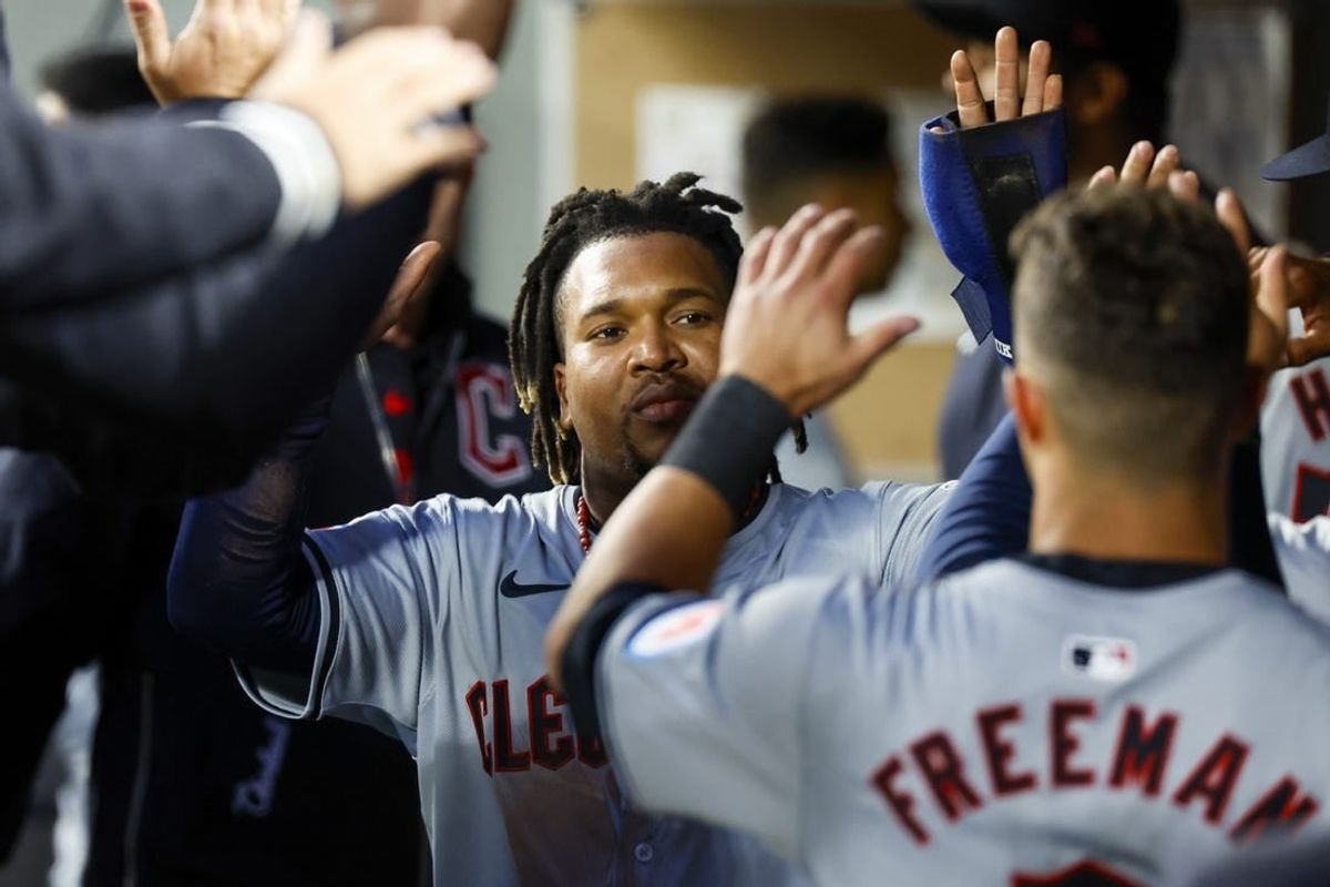 Apr 2, 2024; Seattle, Washington, USA; Cleveland Guardians third baseman Jose Ramirez (11) high-fives teammates in the dugout after scoring a run against the Seattle Mariners during the fourth inning at T-Mobile Park.
