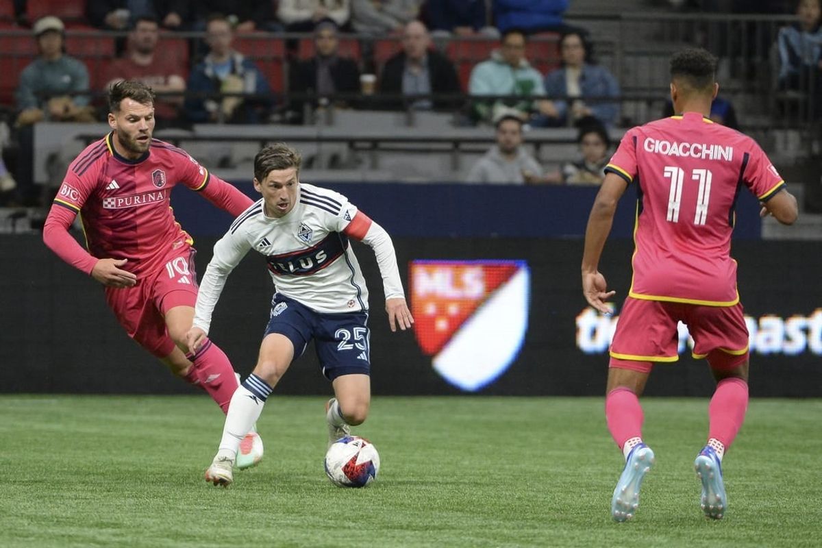 Oct 4, 2023; Vancouver, British Columbia, CAN;  Vancouver Whitecaps FC midfielder Ryan Gauld (25) controls the ball against St. Louis City SC midfielder Eduard Lowen (10) during the first half at BC Place.