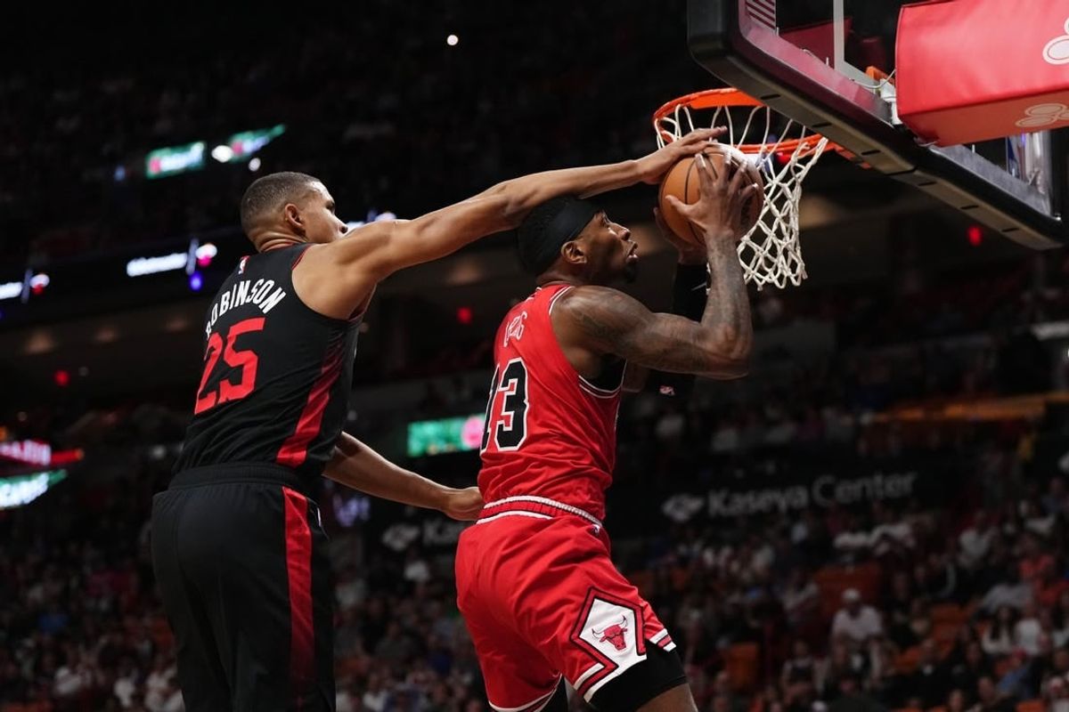 Dec 16, 2023; Miami, Florida, USA; Miami Heat center Orlando Robinson (25) fouls Chicago Bulls forward Torrey Craig (13) during the first half at Kaseya Center.