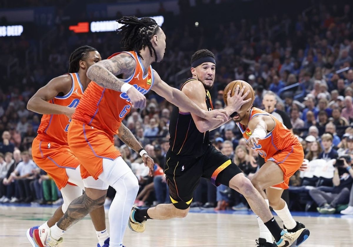Mar 29, 2024; Oklahoma City, Oklahoma, USA; Phoenix Suns guard Devin Booker (1) drives to the basket between Oklahoma City Thunder guard Aaron Wiggins (21) and forward Jaylin Williams (6) during the first half at Paycom Center.