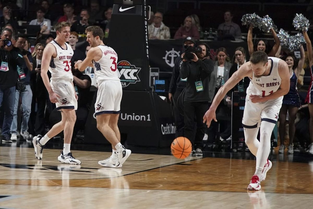 March 12, 2024; Las Vegas, NV, USA; Saint Mary's Gaels guard Luke Barrett (33) and guard Augustas Marciulionis (3) and center Mitchell Saxen (11) celebrate against the Gonzaga Bulldogs after the game in the finals of the WCC Basketball Championship at Orleans Arena.
