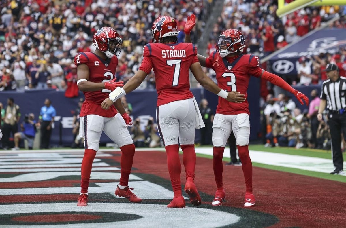 Houston Texans quarterback C.J. Stroud (7) celebrates with wide receiver Robert Woods (2) and wide receiver Tank Dell (3) after a touchdown during the game against the Pittsburgh Steelers at NRG Stadium.