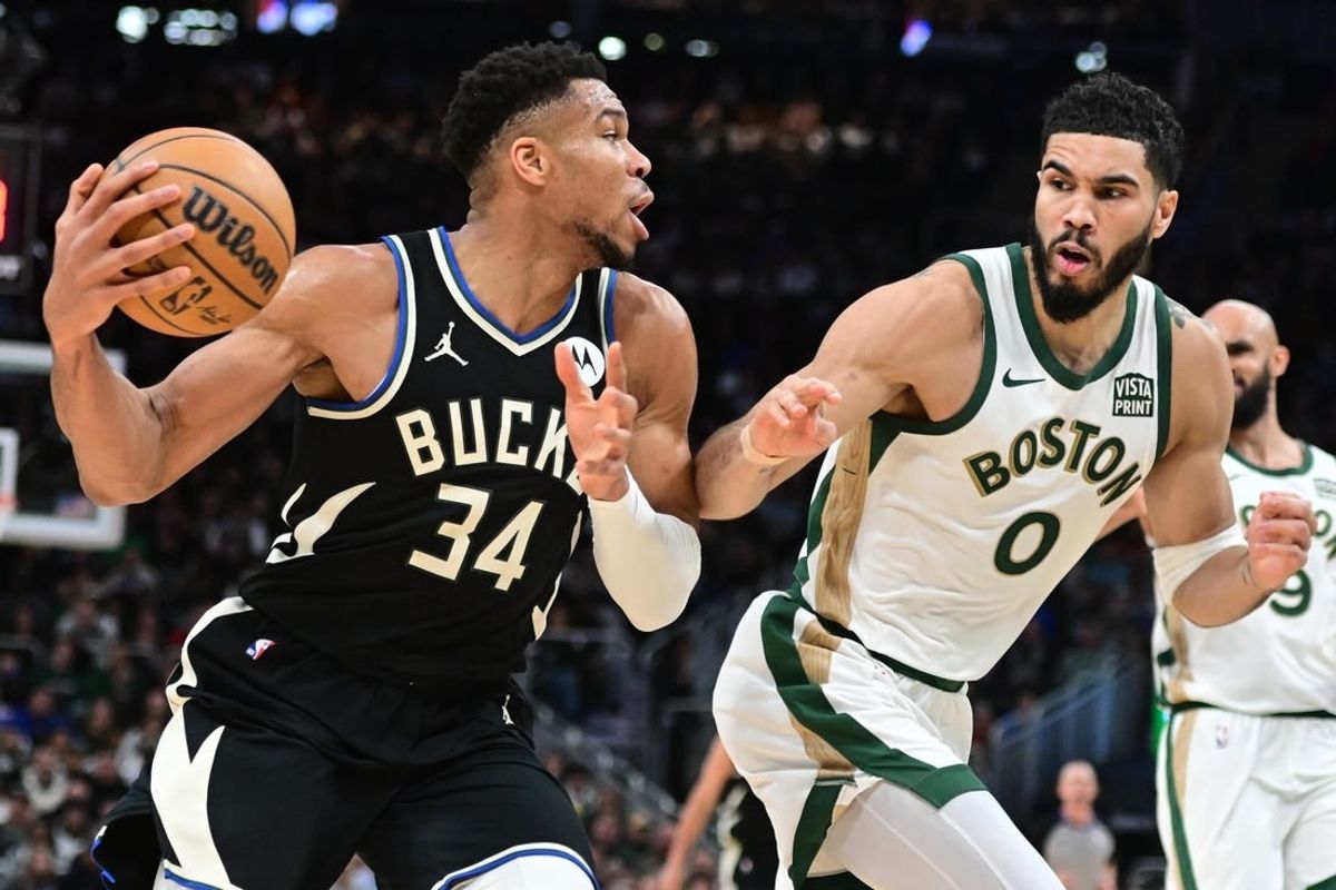 Jan 11, 2024; Milwaukee, Wisconsin, USA; Milwaukee Bucks forward Giannis Antetokounmpo (34) drives for the basket against Boston Celtics forward Jayson Tatum (0) in the second quarter at Fiserv Forum.
