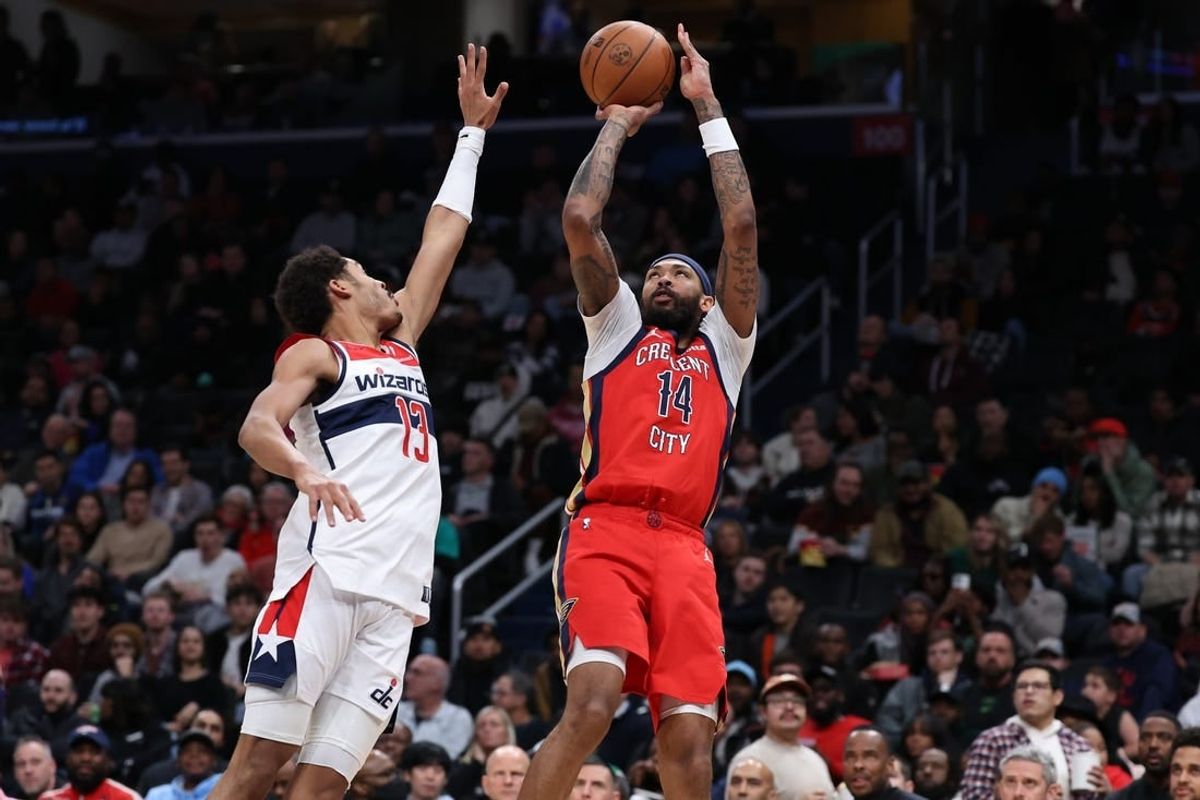 Dec 13, 2023; Washington, District of Columbia, USA; New Orleans Pelicans forward Brandon Ingram (14) shoots the ball over Washington Wizards guard Jordan Poole (13) in the third quarter at Capital One Arena.
