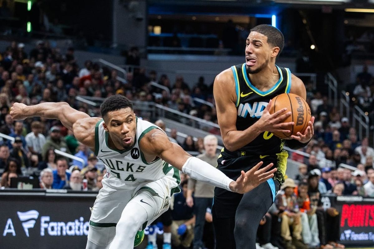 Nov 9, 2023; Indianapolis, Indiana, USA; Indiana Pacers guard Tyrese Haliburton (0) dribbles the ball while Milwaukee Bucks forward Giannis Antetokounmpo (34) defends in the second half at Gainbridge Fieldhouse.