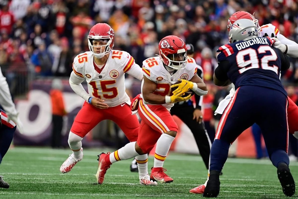 Dec 17, 2023; Foxborough, Massachusetts, USA; Kansas City Chiefs quarterback Patrick Mahomes (15) hands the ball off to running back Clyde Edwards-Helaire (25) during the first half against the New England Patriots at Gillette Stadium.