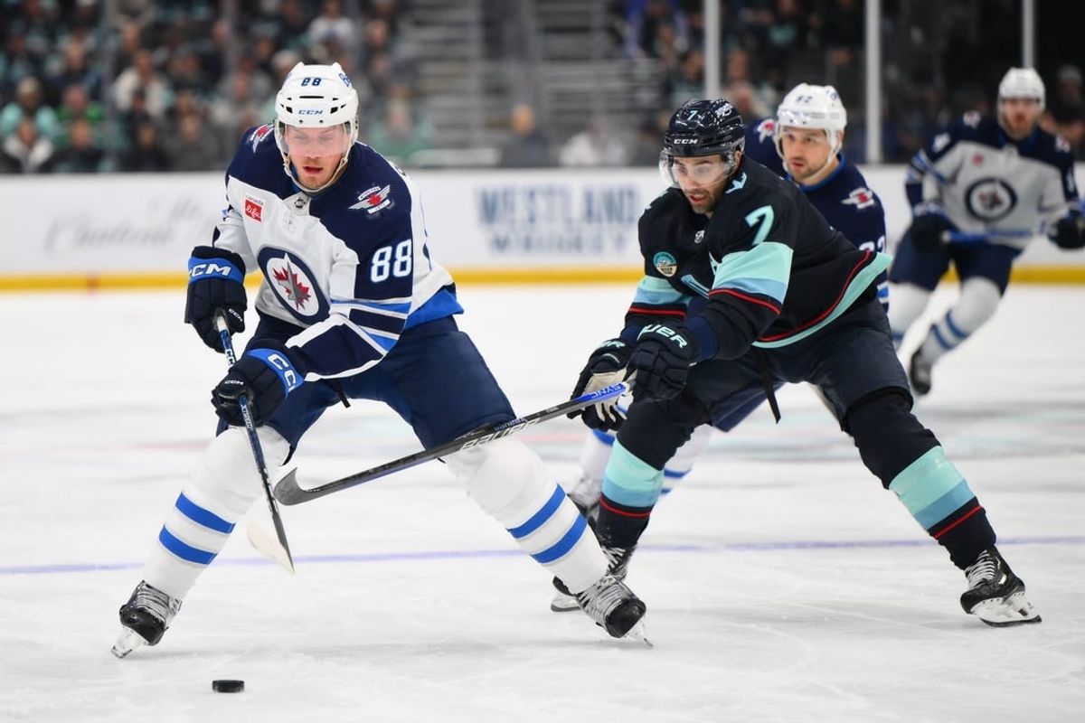 Mar 8, 2024; Seattle, Washington, USA; Winnipeg Jets defenseman Nate Schmidt (88) advances the puck while defended by Seattle Kraken right wing Jordan Eberle (7) during the first period at Climate Pledge Arena.
