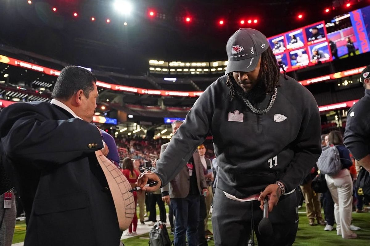 Feb 5, 2024; Las Vegas, NV, USA; Kansas City Chiefs offensive tackle Lucas Niang (77) draws on the stomach of Guillermo Rodriguez Super Bowl LVIII Opening Night at Allegiant Stadium.
