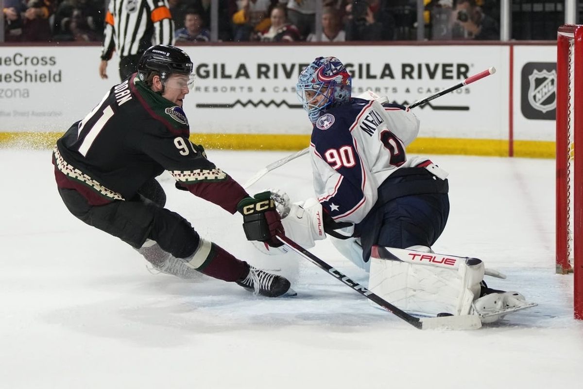 Mar 26, 2024; Tempe, Arizona, USA; Columbus Blue Jackets goaltender Elvis Merzlikins (90) makes the save on Arizona Coyotes right wing Josh Doan (91) in the second period at Mullett Arena.