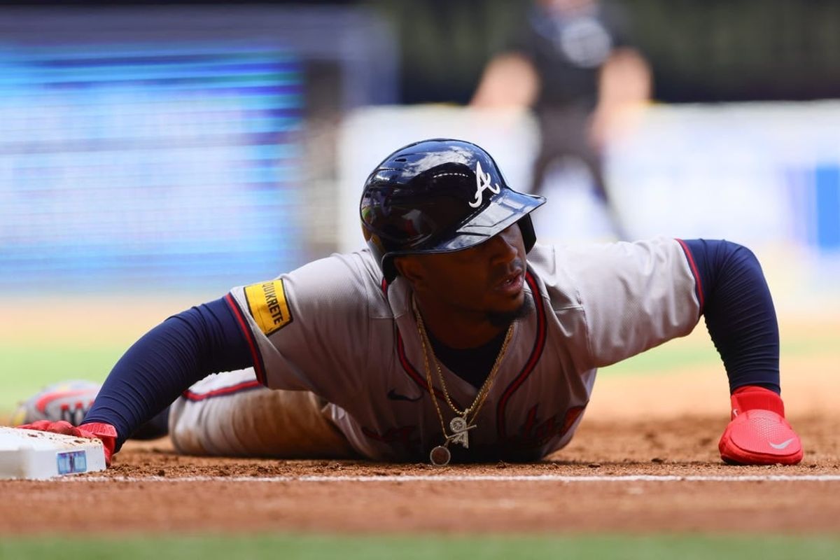Apr 14, 2024; Miami, Florida, USA; Atlanta Braves second baseman Ozzie Albies (1) slides back to first base against the Miami Marlins during the third inning at loanDepot Park.