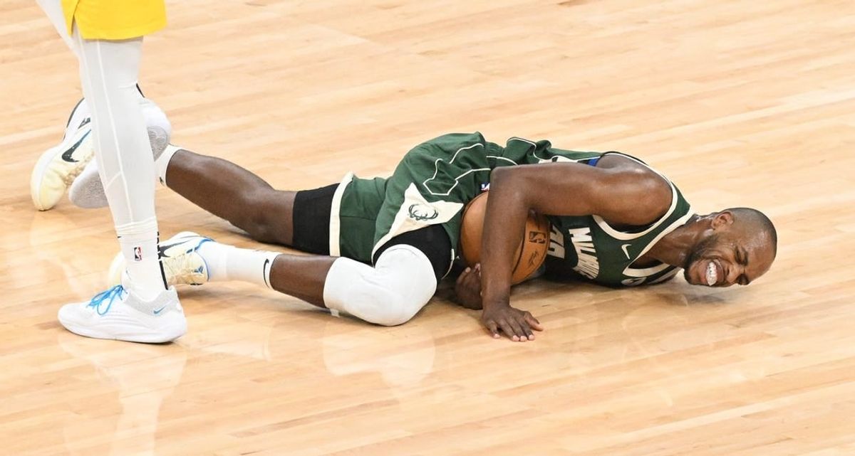 Apr 23, 2024; Milwaukee, Wisconsin, USA; Milwaukee Bucks forward Khris Middleton (22) reacts after an injury against the Indiana Pacers in the first half during game two of the first round for the 2024 NBA playoffs at Fiserv Forum.