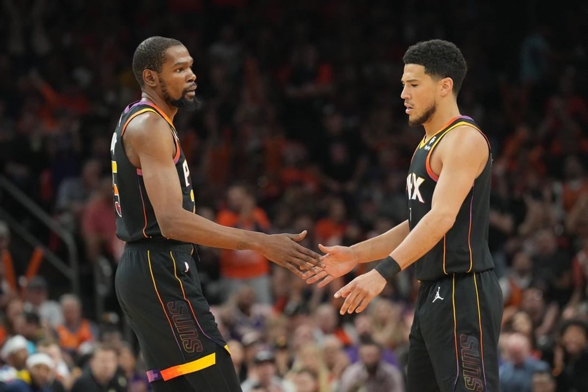 May 11, 2023; Phoenix, Arizona, USA; Phoenix Suns forward Kevin Durant (35) and Phoenix Suns guard Devin Booker (1) slap hands during the first half of game six of the 2023 NBA playoffs against the Denver Nuggets at Footprint Center.