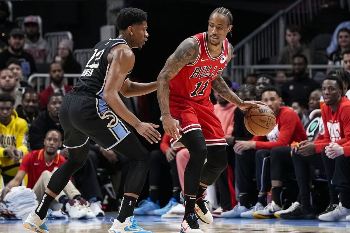 Feb 12, 2024; Atlanta, Georgia, USA; Chicago Bulls forward DeMar DeRozan (11) dribbles against Atlanta Hawks forward De'Andre Hunter (12) during the first half at State Farm Arena.