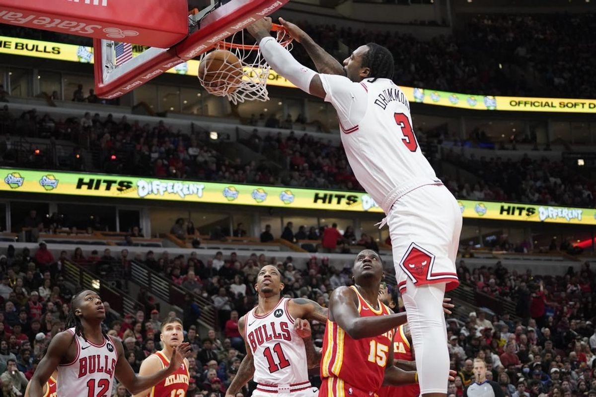 Dec 26, 2023; Chicago, Illinois, USA; Chicago Bulls center Andre Drummond (3) dunks the ball over Atlanta Hawks center Clint Capela (15) during the first quarter at United Center.