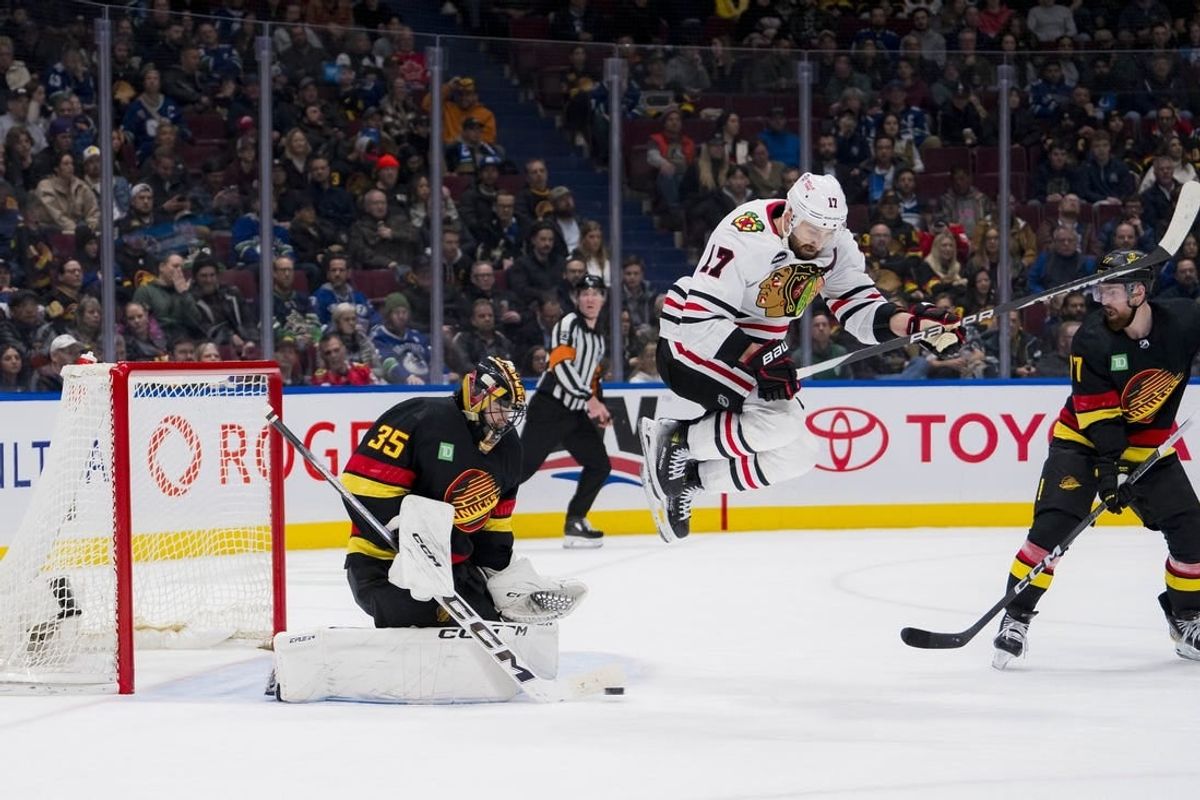 Jan 22, 2024; Vancouver, British Columbia, CAN; Vancouver Canucks defenseman Filip Hronek (17) watches as goalie Thatcher Demko (35) makes a save behind leaping Chicago Blackhawks forward Nick Foligno (17) in the second period at Rogers Arena.
