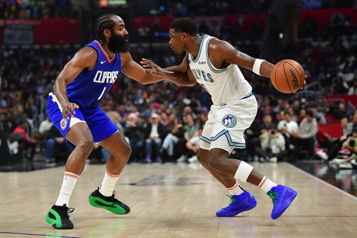 Mar 12, 2024; Los Angeles, California, USA; Minnesota Timberwolves guard Anthony Edwards (5) controls the ball against Los Angeles Clippers guard James Harden (1) during the first half at Crypto.com Arena.