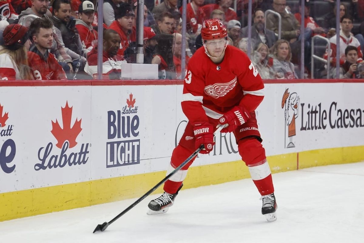 Dec 14, 2023; Detroit, Michigan, USA; Detroit Red Wings left wing Lucas Raymond (23) skates with the puck in the second period against the Carolina Hurricanes at Little Caesars Arena.