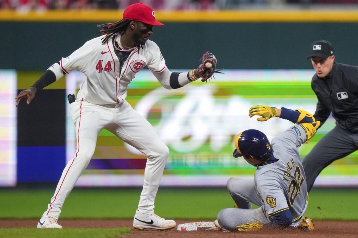 Milwaukee Brewers outfielder Christian Yelich (22) slides into second base safely after hitting a two-run double in the fifth inning of a baseball game against the Cincinnati Reds, Tuesday, April 9, 2024, at Great American Ball Park in Cincinnati.