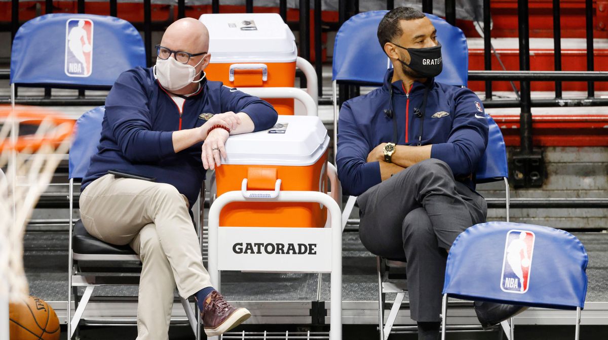 Vice President of basketball operations David Griffin of the New Orleans Pelicans (left) talks with general manager Trajan Langdon prior to the game against the Miami Heat