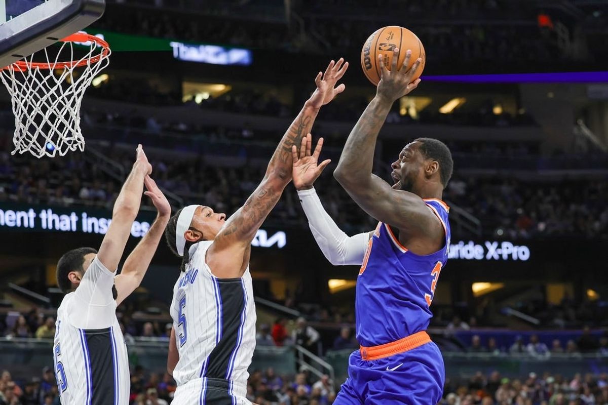 Dec 29, 2023; Orlando, Florida, USA; New York Knicks forward Julius Randle (30) shoots against Orlando Magic forward Paolo Banchero (5) during the first quarter at KIA Center.